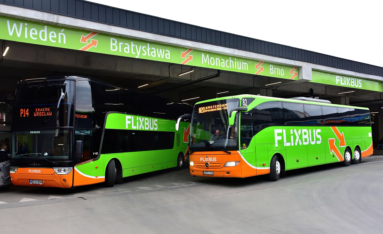 Two green FlixBus coaches under the roof of the MDA bus station