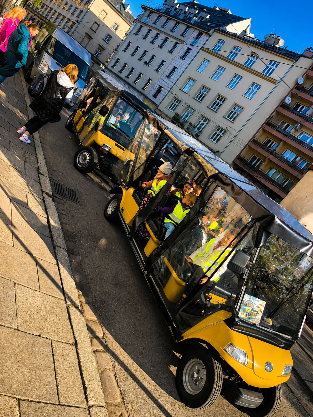 YourKrakow electric carts as a tour group boards in Krakow