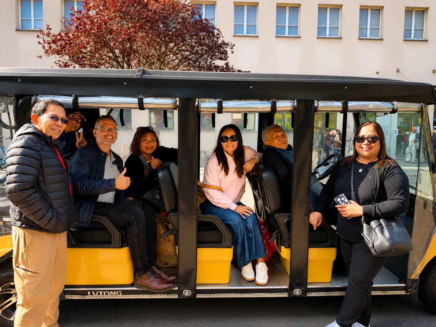 Happy guests inside a YourKrakow electric cart in Krakow